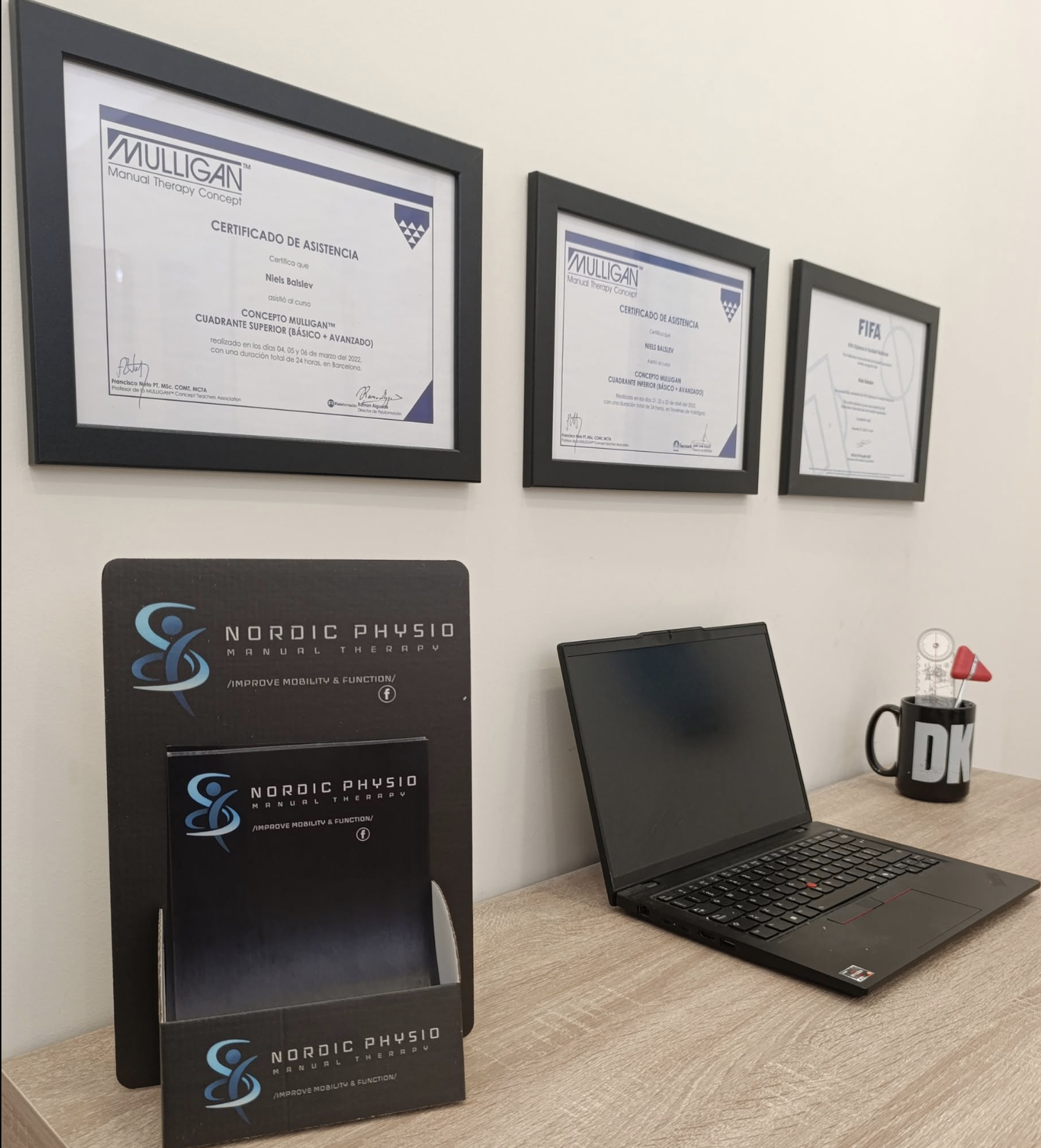 Framed Mulligan Manual Therapy Concept and FIFA course certificates on the Nordic Physio clinic wall